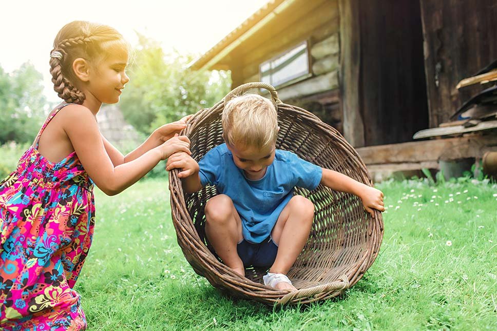 cute-little-boy-and-girl-having-fun-together-and-playing-with-hurdled-basket-on-the-backyard-of-old_t20_B8gmZx.jpg